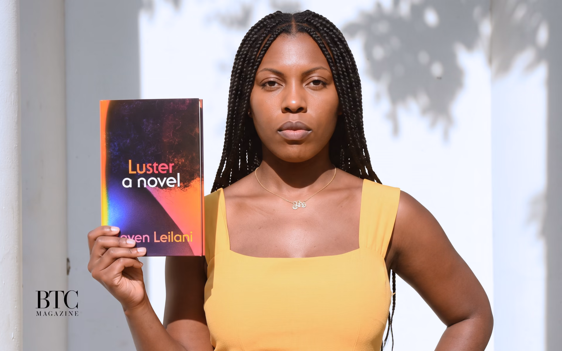 Black woman reading Luster novel by Raven Leilani